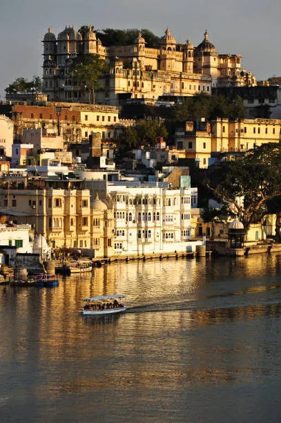 /uploads/gallery/e93946f8-7619-442f-9e6b-1cbd1c5d69ed_a-tour-boat-drifts-beneath-the-imposing-city-palace-of-udaipur-at-sunset-rajasthan-india.webp